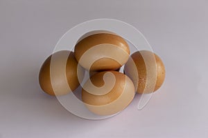 Top view of five fresh eggs on white background