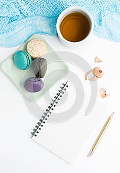 Top view flat lay Blank white notebook mockup with macarons and tea cup. Art, writing concept