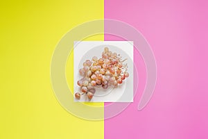 Top view of flat lay of bunch of grapes on double color sirface background f