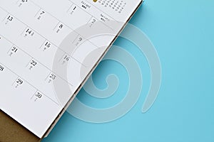 Top view or flat lay of calendar page on blue background with copy space, ready for adding or mock up