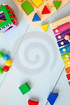 Top view or flat lay on colorful toys on wooden background with copy space. Warm vintage filter