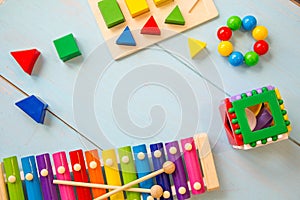 Top view or flat lay on colorful toys on wooden background with copy space. Warm vintage filter