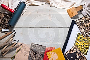 Top view flat lay of Printmaking tools for woodcut relief print photo