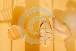 top view and flat lay summer fruit from mango slice and juice with shadow of tropical leaf and yellow background