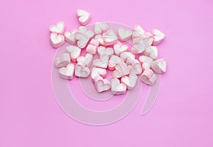 Top view, Flatlay template design of candy color marshmallows on pink background with copy space