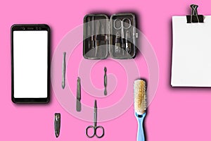 Top flat lay, top view manicure pedicure equipment on pink backgrounew black smartphone isolated on white background for mock up