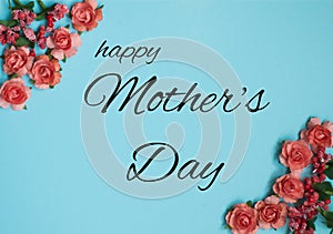 Top view of floral frame made of pink roses on blue background with happy mothers day lettering