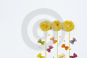 Top view flowers and butterflies made out of various pasta on white background.Copy space, place for text