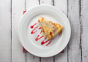Top view of folded pancake on white plate