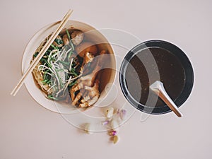 Top view. Food of Thailand. Braised Chicken Noodle Consisting of blood and chicken feet Yellow egg noodles, steamed bitter gourd,