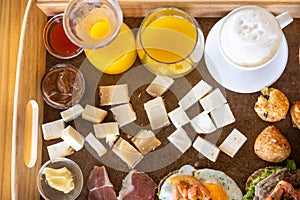 Top view of a food tray filled with different variations of food and drinks