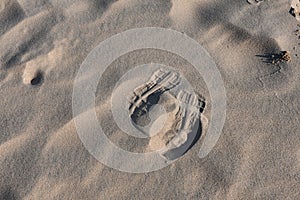 Top view of footprints on the sand on the bea