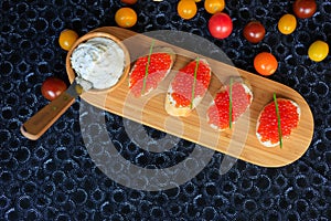 Top view of four sandwiches with red caviar