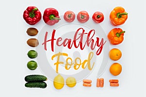 top view of frame with vegetables and fruits and text Healthy Food