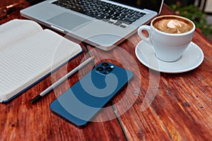 Top view of a freelancer workspace in a cafe