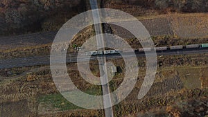 Top View Freight Train Passing Railway Crossing. Aerial Drone View Flight Over