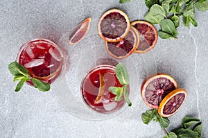 Top view of fresh alcohol drink with blood oranges, ice and mint.Refreshing juicy summer drink