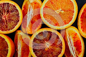 Top view of fresh blood orange halves and quaters. Fruit background