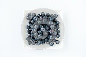 Top View of Fresh Blueberries on a Square Plate isolated on White