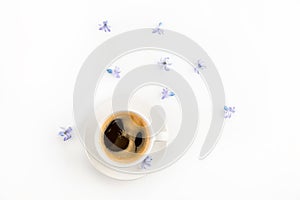 Top view of fresh coffee in cup and blue hyacinth flowers photo