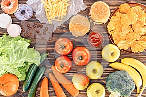 top view of fresh fruits with vegetables and assorted unhealthy food