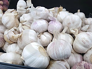 Top view of fresh garlics as a background for sale in the market