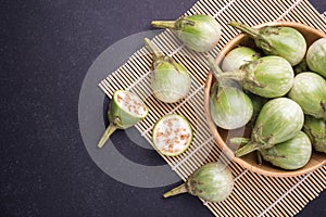 Top view fresh green Thai eggplant on black stone