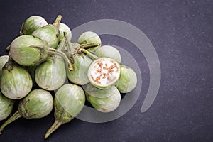 Top view fresh green Thai eggplant on black stone