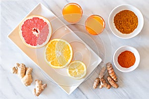 Top view of fresh healthy ingredients for citrus tumeric juice