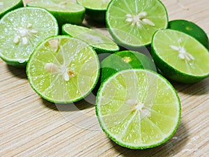 Top view of fresh lemons sliced on wooden table as a background