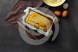 Top view fresh loaf cornbread dark background