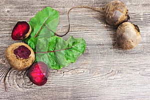 Top view at fresh organic beets with leaves on wooden rustic background. Close up view