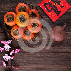 Top view of fresh persimmons on wooden table background for Chinese lunar new year