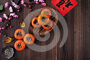 Top view of fresh persimmons on wooden table background for Chinese lunar new year