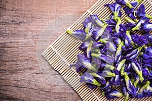 Top view fresh purple Butterfly pea flower on wooden board background