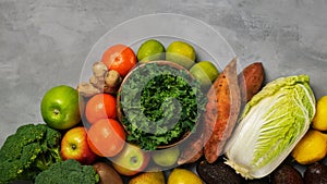 Top view of fresh raw vegetables, fruits on gray background banner. Different varieties of cabbages, chinese cabbage, broccoli,