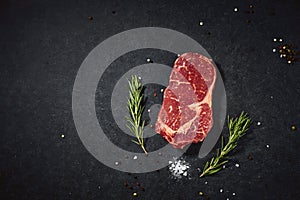 Top view fresh red raw meat with spice and salt. Beef steak on a dark table flat lay copy space background