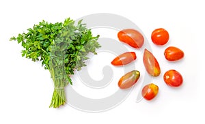 Top view of fresh red tomatoes and a bunch of green parsley leaves