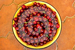 Top view of Fresh Ripe cherries in bowl on table background. Summer fruit. Healthy food concept. Copy space, top view