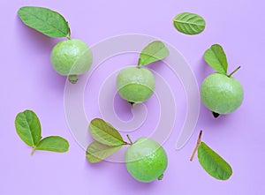 Top view of fresh ripe guava with leaves on pink