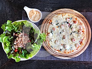 Top view of Fresh salad with tuna and pizza on white plate , Healthy food.