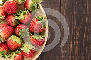 Top view fresh strawberries on old wooden background