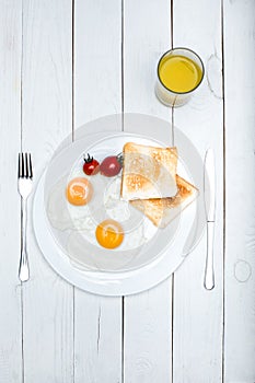 top view of fresh tasty breakfast with fried eggs and toasts