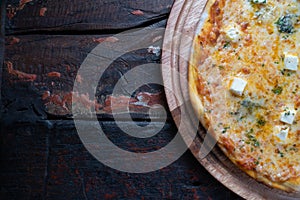 Top view of fresh tasty pizza on rustic wooden table. Copy space