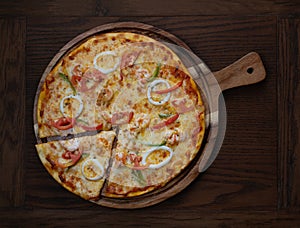 Top view of fresh tasty pizza on wooden background