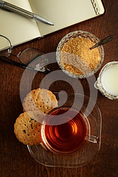 Top view fresh tea with cookies and note book