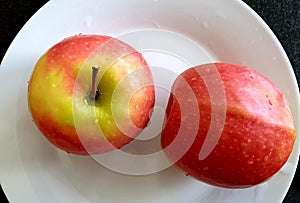 Top view of fresh wet apples laid on a plate