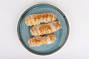 Top view of freshly baked sausages in sesame seed batter.