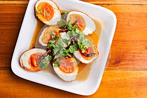 Top view fried boil chicken eggs with tamarind sauce, topped with dried chili and coriander. The food is called Kai-Loog-Keay in