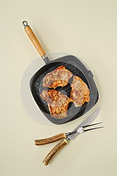 Top view of fried chopped pork tenderloin on frying pan